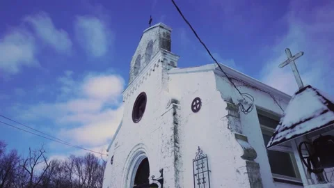 Super wide angle close up pan of old stone church in winter Stock Footage 148677049