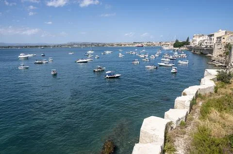 Super wide angle view of the Gulf of Syracuse with many boats and blue water Stock Photos