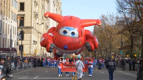 The Super Wings Jett Float in Macy's Thanksgiving Day Parade with throngs of Stock Footage 120711771