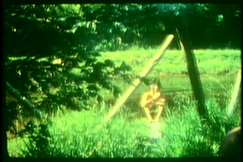 Super8 man eating at the lake Stock Footage 40736438