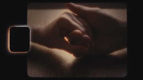Super8 shot of two hands gently holding each other Stock Footage 301821414