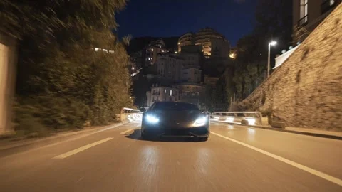 Supercar driving fast through monaco cityscape at night Stock Footage 330956735