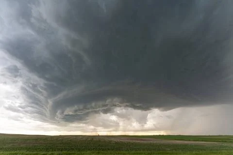 Supercell storm clouds gathering over green fields Dramatic supercell thun... Stock Photos