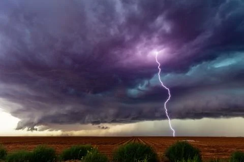 Supercell thunderstorm with lightning bolt. Stock Photos