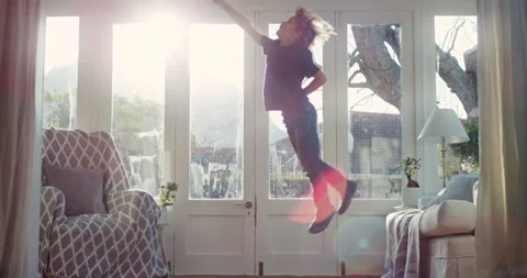 Superhero, child and jumping on couch, freedom and boy with energy in living Stock Footage 331466425