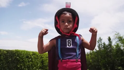 Superhero kid flexes his biceps Stock Footage 69179088