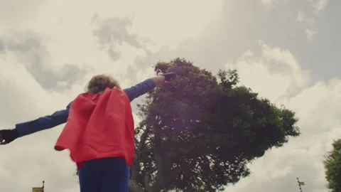 A Superhero kid jumping on a trampoline Stock Footage 279186433