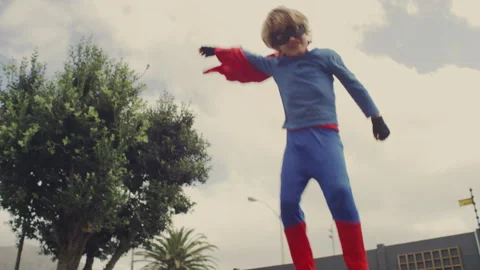 Superhero kid jumping on a trampoline Stock Footage 279219866