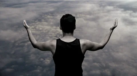 Superhero powerful strong man male. on top. clouds. heaven. hands up Stock Footage