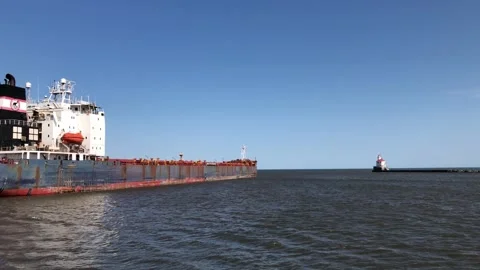 SUPERIOR, WI - 5 OCT 2020: ALGOMA GUARDIAN ship and lighthouse on lake. Stock Footage 148356858
