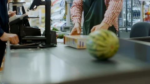 At the Supermarket: Checkout Counter Hands of the Cashier Scans Groceries Fruits Stock Footage