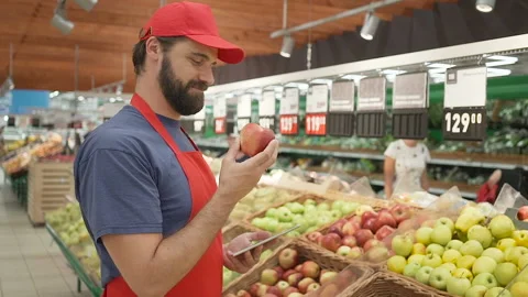 Supermarket clerk checking quality of apples, freshness and top quality food Stock Footage 92662231