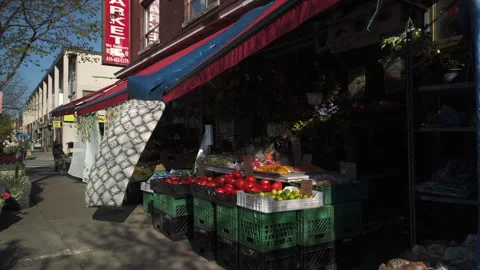 A supermarket fruit stand on Danforth Avenue in Toronto, wind blowing through Stock Footage 312798898