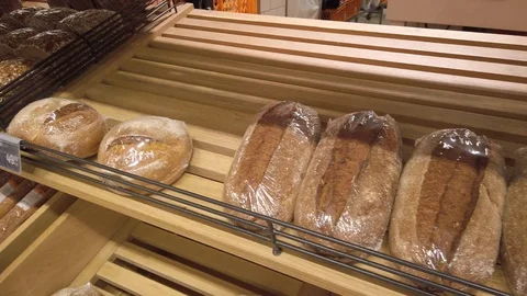 Supermarket, a large rack with fresh bread. Products of our own bakery. Stock Footage 121783517