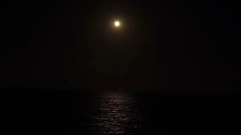 Supermoon shining brightly in the night sky reflecting off the Mediterranean Sea Stock Footage 266837925