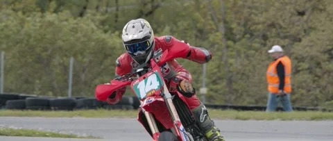 Supermoto exiting corner during a race Stock Footage 276103530