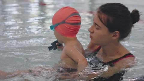 A Supervised Swimming Lesson for a Young Child with Their Instructor in the Stock Footage 312435350