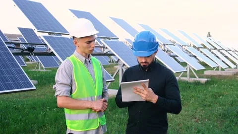 Supervising engineer with a worker who reads the construction plan. Stock Footage 140002334