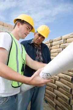 Supervisor And Co-Worker With Blueprint Stock Photos