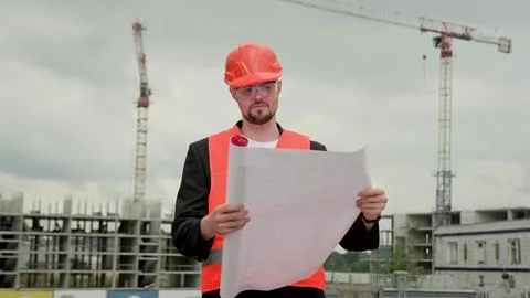 Supervisor with big plan working at construction site Stock Photos