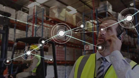 Supervisor calling on headset, activating node overlay linking racks and Video stock 320651509