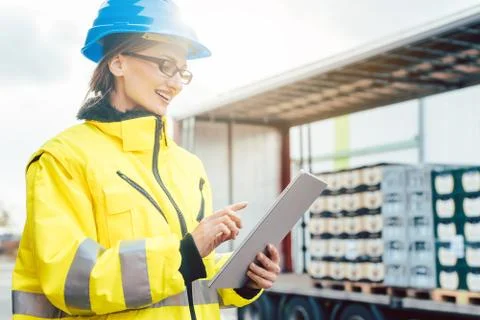 Supervisor checking contents of shipment to be sent by truck Stock Photos