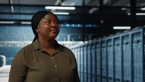 Supervisor in data center overseeing large scale IT equipment Stock Photos