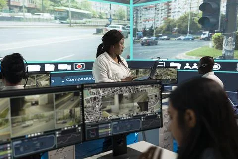 Supervisor discussing printed reports with traffic operators Stock Photos