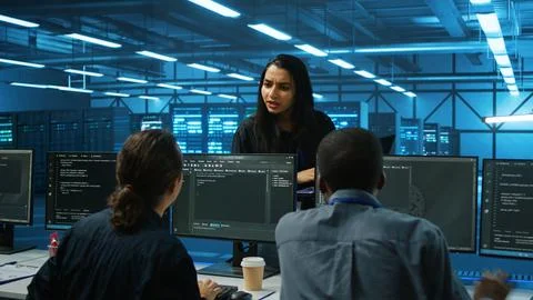 Supervisor doing inspection in server hub, taking feedback from workers Stock Photos