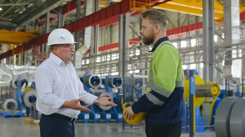 Supervisor engineer argue and lecture with the upset worker in workshop of big Stock Footage 121869415