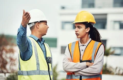 Supervisor, engineering and angry with people on construction site for project Stock Photos
