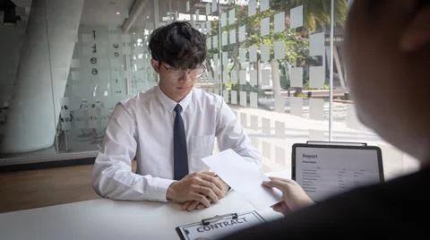 Supervisor gives the document envelope to the employee, supervisor submits th Stock Photos