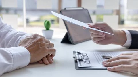 Supervisor gives the document envelope to the employee, supervisor submits th Stock Photos