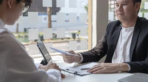 Supervisor gives the document envelope to the employee, supervisor submits th Stock Photos