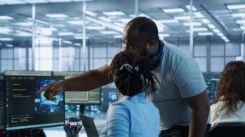 Supervisor overseeing worker using AI system software Stock Photos