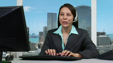 Supervisor at PC talking on headset Stock Footage 512268