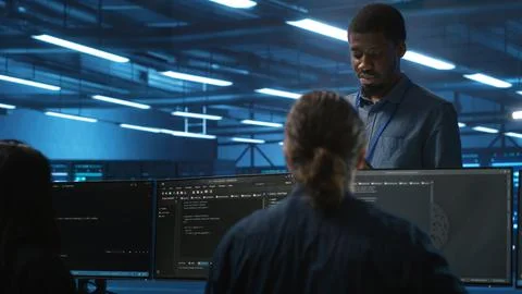 Supervisor in server hub workplace managing diverse team of developers Stock Photos