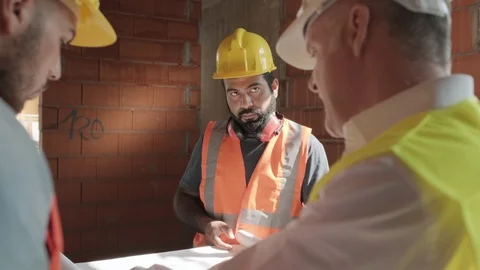 Supervisor Showing Building Plans To Workers In New House Video stock 98285530