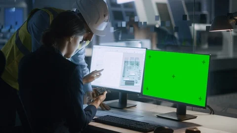 Supervisor Talks to Female Engineer Who's Working on a PC with Green Screen Stock Footage 125481289
