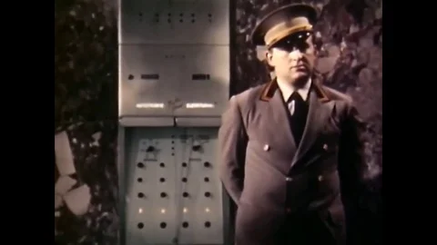 A supervisor turns the traffic flow dial and passengers board an elevator, in an Stock Footage 79515760