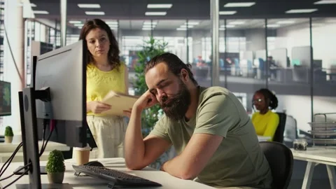 Supervisor waking up tired sleeping employee at desk Video stock 318160741