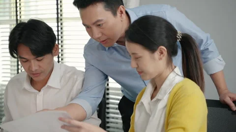 Supervisor is walking around the office, providing guidance to the juniors. Stock Footage 274358330