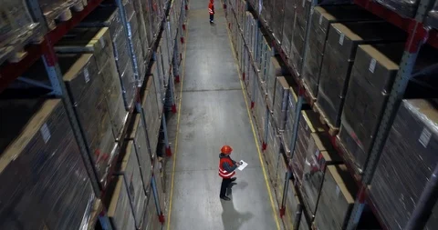 A supervisor walks through an industrial warehouse Stock-Footage 119926333