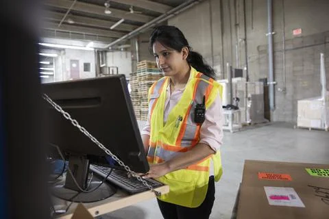 Supervisor working on computer in distribution warehouse Stock Photos