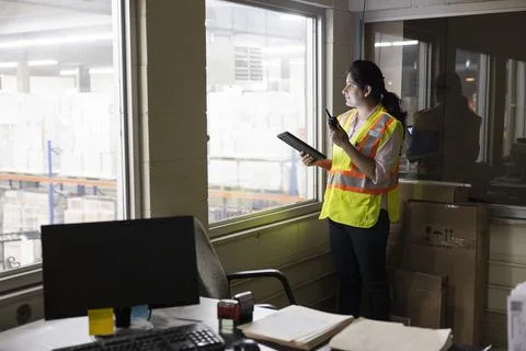 Supervisor working with digital devices in warehouse office Stock Photos