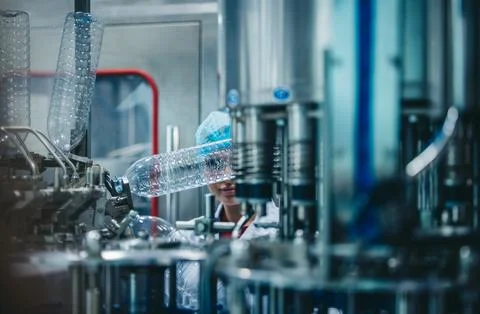 Supervisors check automated bottling for sequence accuracy, safety, reliabi.. Stock Photos