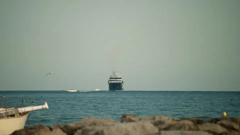 Superyacht navigating vast ocean under a clear sky, symbolizing wealth, travel, Stock Footage 339805307
