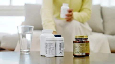 Supplement Bottles and Water Filter on Home Table Stock-Footage 338372208