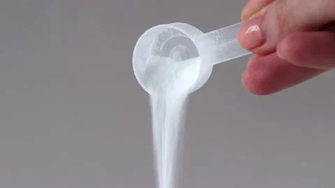 Supplement with a scoop of BCAA powder and sports nutrition Stock Footage 234405997