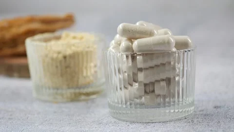 Supplements on display in two clear bowls on table Stock Footage 334697232
